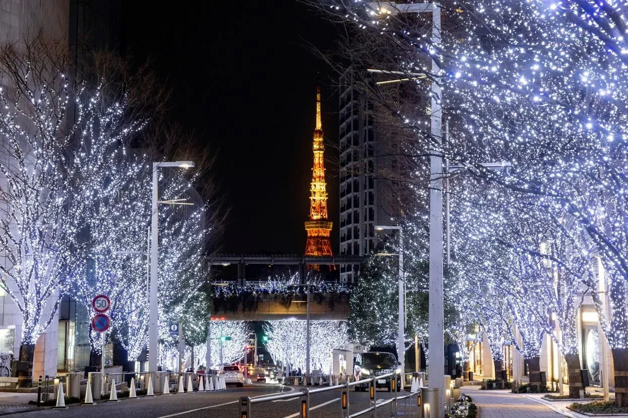 Keyakizaka avenue at Roppongi Hills lit in white and blue, with Tokyo Tower at the end of the street